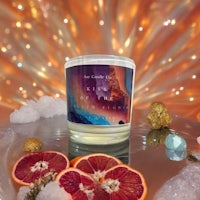 a candle with blood oranges on top of it