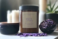 a jar of lavender with a candle next to it
